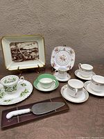 Full view of all china pieces including Paragon teacups and saucers, Spal Lisboa dish, Royal Albert pieces, and a cake server.