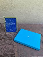 Photo of the vintage Seagull pewter photo frame standing next to the blue Birks box on a textured surface.