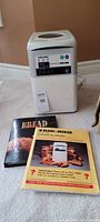 Photo showing Black and Decker bread maker with two bread-making books in front.