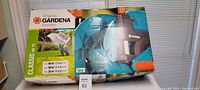 Full box view with Gardena branding and hose reel visible