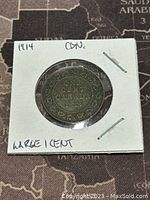 Front view of 1914 Canadian large one cent coin showing denomination and year inside circular wreath.
