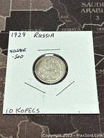 Front side of 1929 Russian 10 Kopeks silver coin in white cardboard holder showing denomination and date