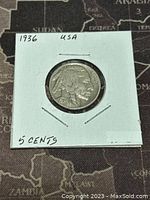 Front side of the 1936 US Buffalo Nickel showing the Native American profile and date, held in a cardboard coin holder with handwritten labels.