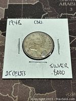 Reverse of 1948 Canadian 25 cent silver coin showing caribou and denomination details.