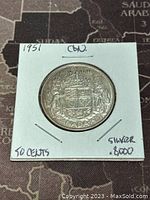 Reverse side showing Canadian Coat of Arms with detailed engravings and silver purity marking.