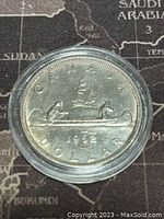 Reverse side of the coin showing canoe with two figures and inscriptions