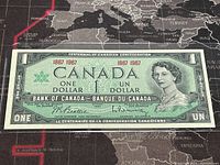 Front of the banknote showing Queen Elizabeth II portrait, denomination, and centennial text.
