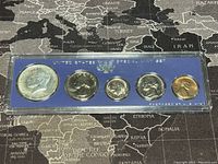 Front side of 5 coin set from 1967 in blue plastic case labeled 'United States Special Mint Set' showing heads designs including Kennedy half dollar.