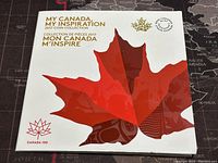 Front cover of the coin set folder showing 'My Canada, My Inspiration' 2017 coin collection with a large stylized red maple leaf and bilingual English/French text.