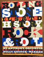 Front cover of 'Rolling Stone Illustrated History of Rock & Roll' book with colorful block lettering