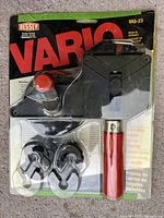 Front view of Bessey Vario VAS-23 strap clamp in original packaging, showing the clamp mechanism, handle, and four clips.