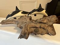 Front angle of the driftwood art with whale figures on top, showing the natural wood texture and whale placement.