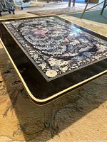 Side view of Korean low table showing foldable metal hairpin leg and inlaid top edge.