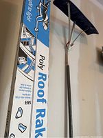 Close-up photo of the poly roof rake box showing product name and features.