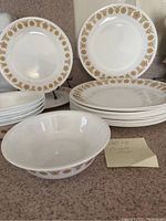 Close view of plates and bowl with gold border