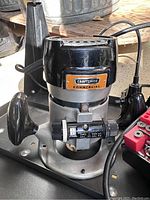 Close-up of Craftsman commercial router showing brand and model tags, adjustment knob, and mounting base.