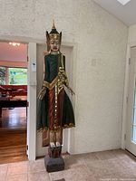 Front view of full-height statue showing posture, attire and base