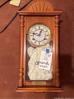 Wooden framed Statue of Liberty Centennial Clock with columns and glass front door, showing approximate dimensions taped on the glass.