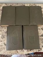 Five green hardcover vintage books by Arthur Train, arranged with three on top and two below on a flat surface.