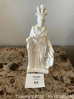 Front view of the white alabaster Athena statue on a marble surface