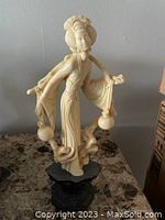 Front and side view of the Geisha statue showing the facial features, water vessels and detailed flowing robes