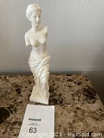 Front view of the alabaster statue of Greek Goddess Aphrodite showing detailed figure on base.