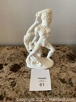 Front and angled side view of the alabaster sculpture showing Hercules lifting Lichas on oval base.