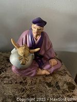 Front view of hand painted Hakata figurine showing seated man in traditional Japanese outfit