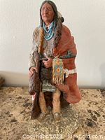 Front view of 16-inch Native American Monfort sculpture showing detailed face, clothing, and accessories.