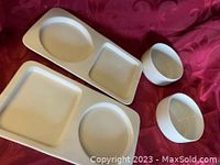 Photo showing 2 white ceramic divided sandwich plates with round and square compartments alongside 2 white ceramic round bowls.