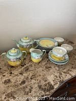 Full view of the 17 piece vintage Japanese Takito tea set on marble surface.