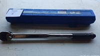 Closed blue hard plastic case with label visible indicating 1/2 inch torque wrench.