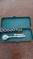 Photo shows 1/4" drive socket set with ratchet, extension bar, and nine sockets from 3/16" to 1/2" in a green steel case.
