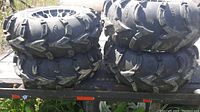 Stacked view of four ATV tires showing overall tread condition