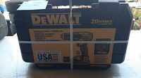 Front of unopened DeWalt 20V Max compact drill/driver kit box in black and yellow carrying case with strapping