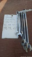 Photo of six Gray Canada metric wrenches sizes 13, 14, 15, 17, 19, 20 showing the tools bundled with a white zip tie next to a hand-written note with the size list.