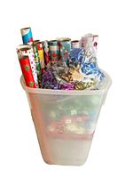 Rubbermaid storage container filled with partial rolls of Christmas wrapping paper and assorted multicolored stick-on bows in sealed and open bags.