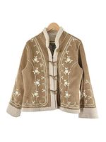 Front view of Noy Classics ladies embroidered shearling jacket hanging on wooden hanger. Shows toggle and zipper closure, floral embroidery and shearling trim.