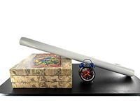 Side angle showing two stacked canvas prints and the Spider-Man alarm clock with a rolled poster behind them.