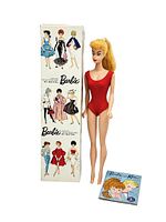Doll standing beside original box and booklet on white background