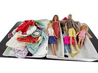Full lot view showing Barbie dolls and assortment of clothing in white case