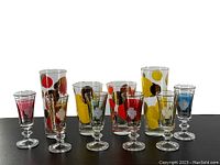 Full set of vintage MCM barware with colorful polka dot highball and lowball glasses plus six sherry/liquor glasses with etched stems.