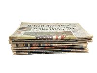 Stack of 8 vintage newspapers showing edges and thickness, some yellowing and wear from age.