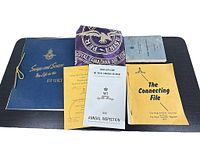 Various Royal Canadian Air Force and Regiment memorabilia including scrapbook, pillowcase, booklets, and manual arranged flat.