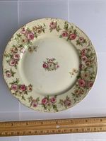 Full view of Haviland scalloped dish with pink rose floral pattern, showing overall condition and size with ruler.