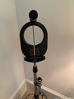 Front view of Memorex microphone mounted on adjustable metal stand near corner of room.