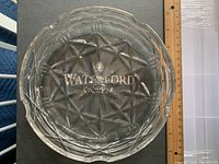 Top view of Waterford crystal ashtray showing intricate cut starburst design and etched logo on the base.