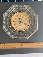 Front view of one Waterford crystal clock resting on a black surface next to a ruler showing approximate 5 inch size.