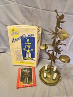 Angel chimes displayed with original box and instruction manual, showing overall condition and components.