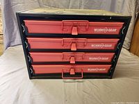 Closed chest with front view of four red drawers labeled Work Gear.
